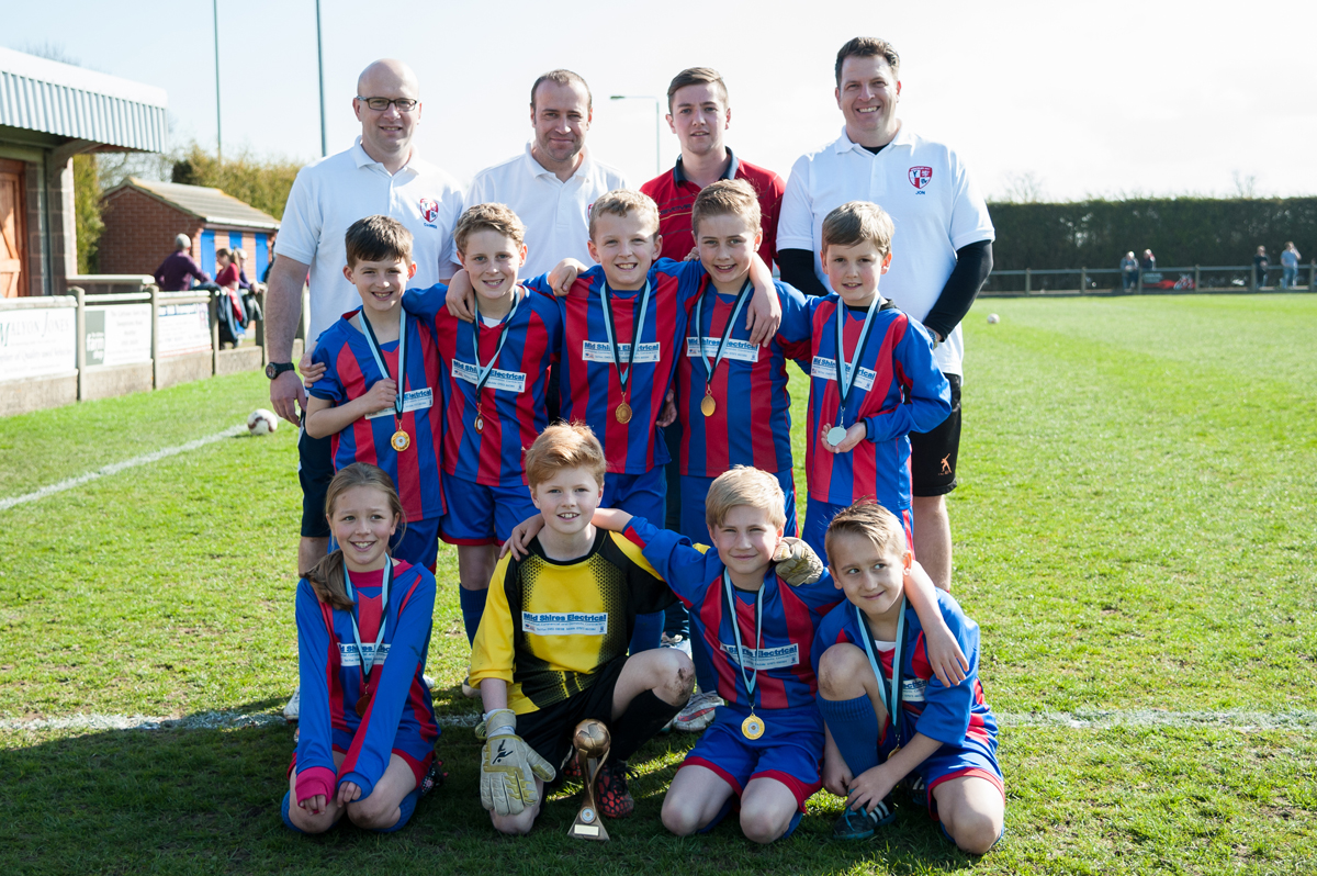 Hinckley AFC's cup winning Under 9s players and coaches are joined by injured striker Michael Healy